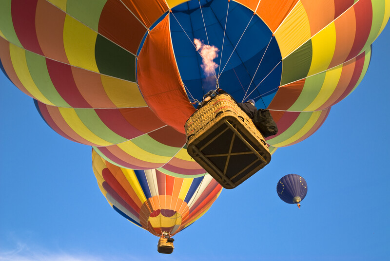 hot air baloons_Balloonist actioning the burner to reach the hot air balloon above_canstockphoto897552